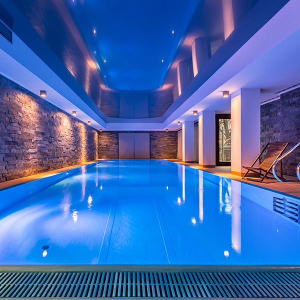 Swimming pool with brick walls, evening view