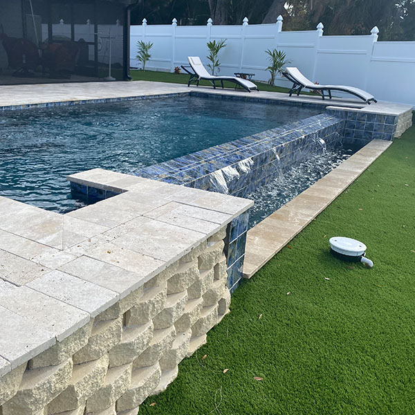 Beautiful new pool in the backyard with a water feature in Lithia, FL