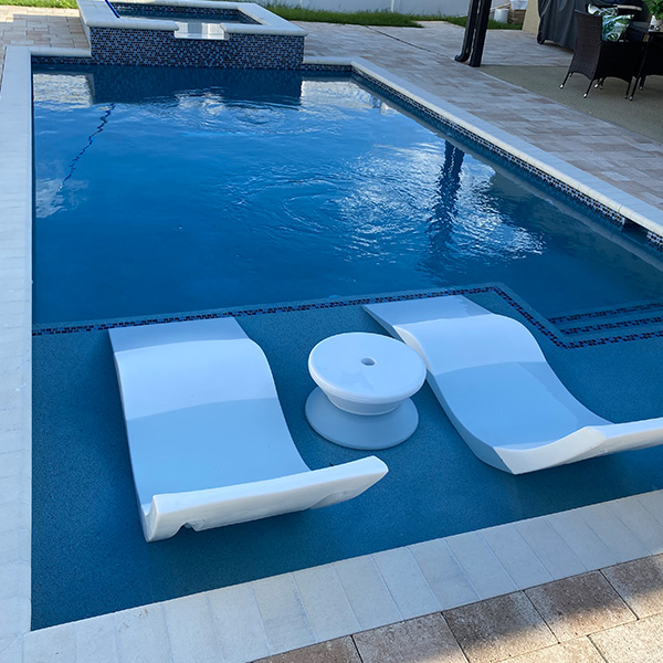 Beautiful new pool in the backyard with a hot tub and sun shelves for lounging in Lithia, FL