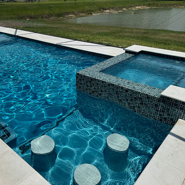 New pool in the backyard with a hot tub and water chairs in Lithia, FL