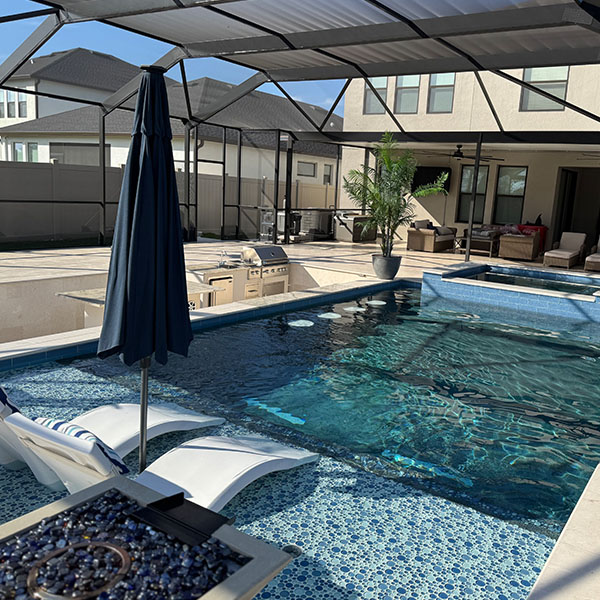 Beautiful new pool in the backyard with a hot tub and an outside kitchen in Lithia, FL