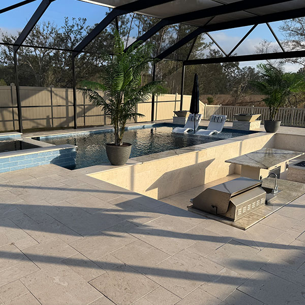 Beautiful new pool in the backyard with a hot tub and an outside kitchen in Lithia, FL